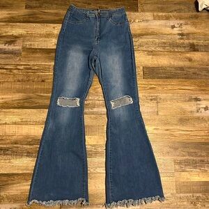 JC & JQ Western boot cut bell bottom jeans with fringed hem.